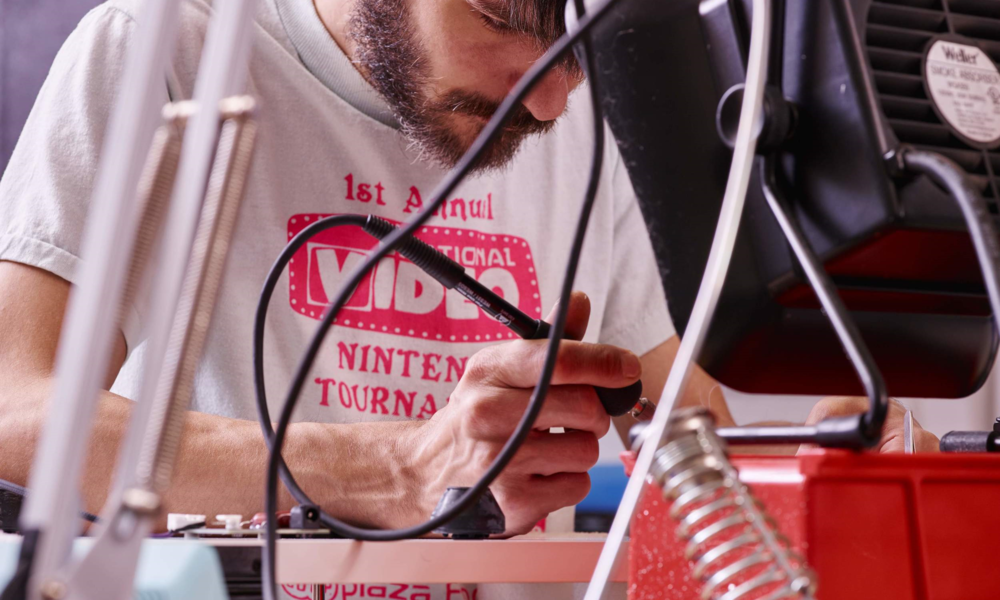 Tonearm wires being soldered to a PCB